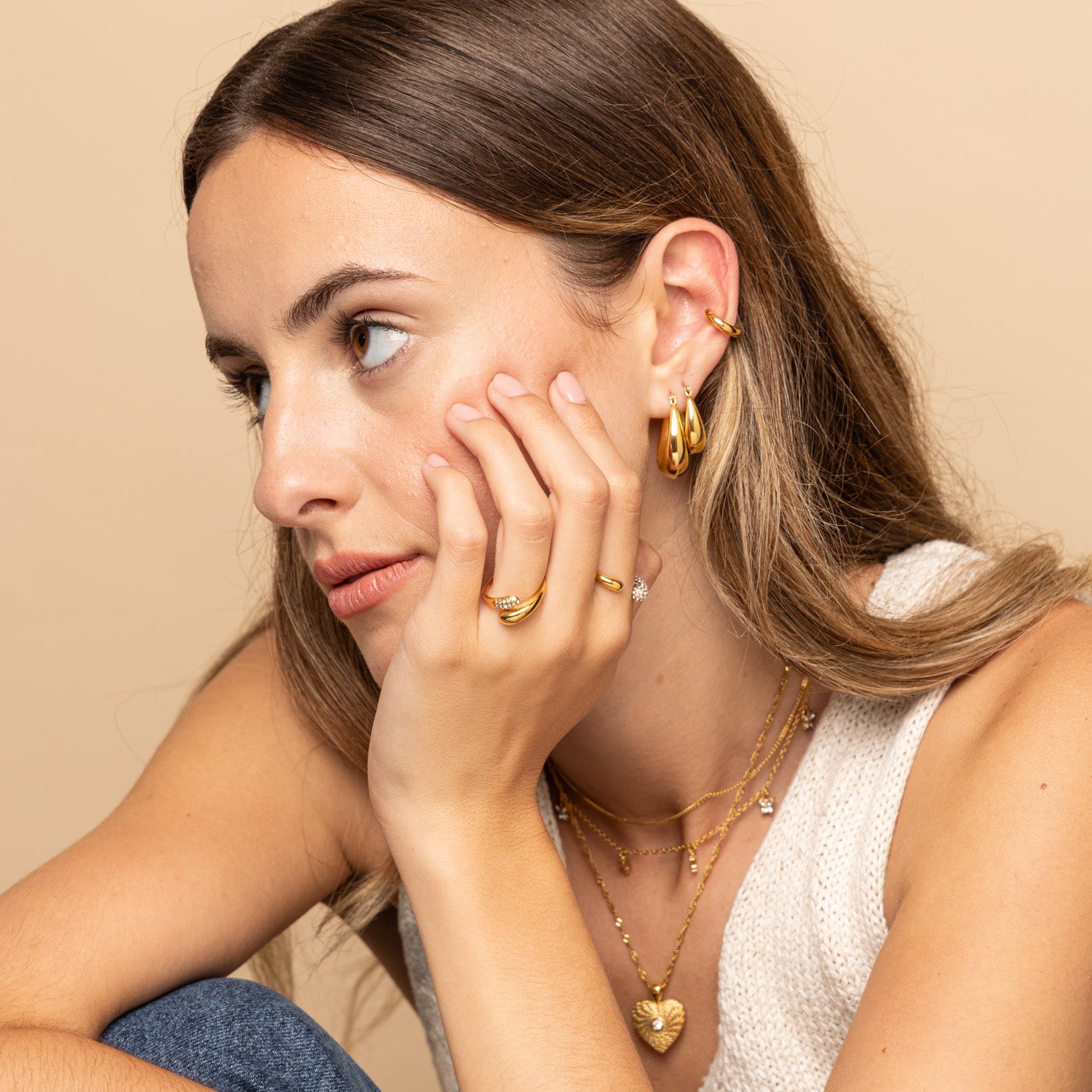 Model wearing stacked Gold Thick Oval Hoop Earrings by Zoi Era – layered chunky oval gold hoops, waterproof and anti-tarnish jewellery for modern styling.