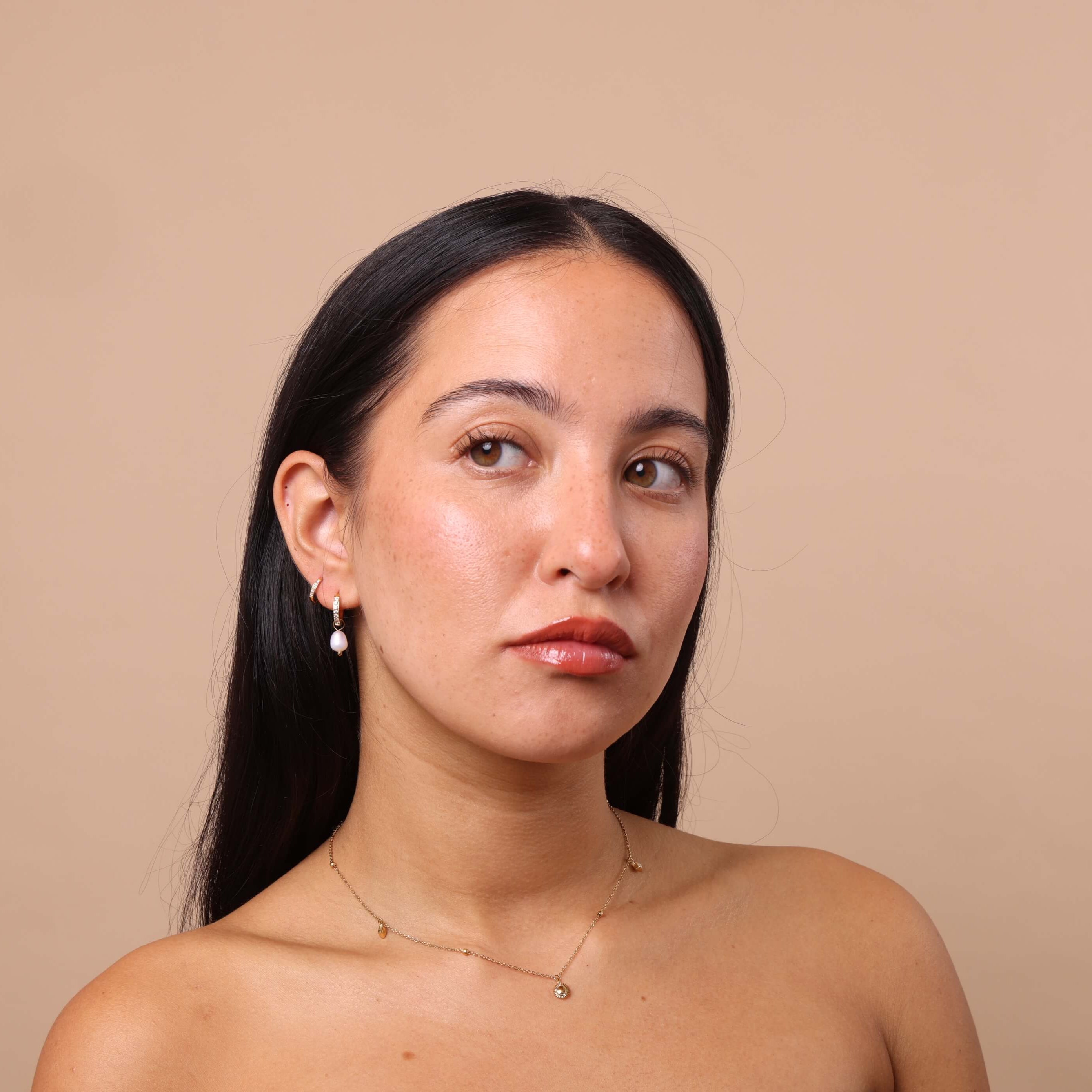 Close-up of ear stack featuring Crystal Pearl Charm Hoops – dainty crystal hoops styled with pearl charms, waterproof anti-tarnish earrings.