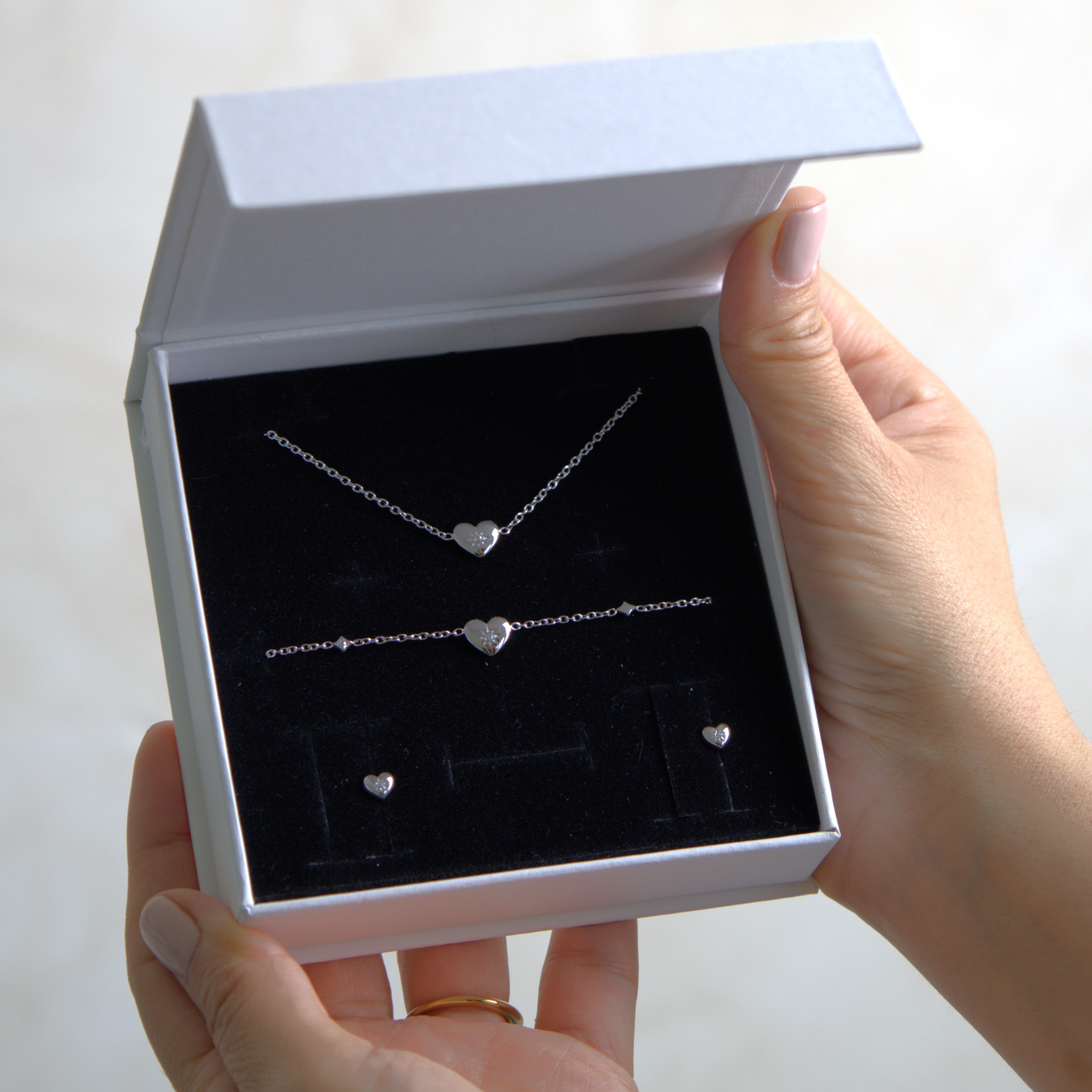 Silver heart-shaped jewelry set in a white gift box