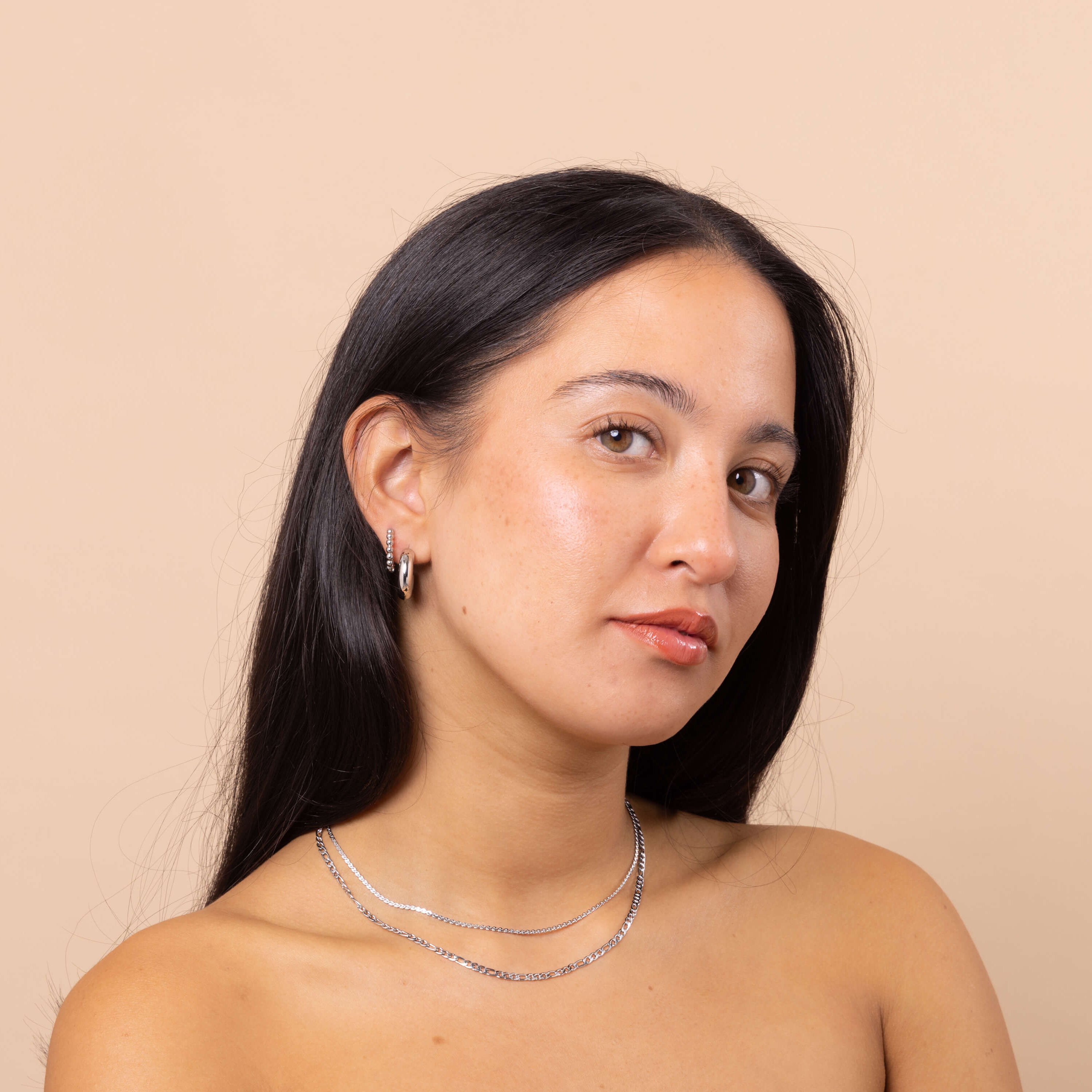 Model wearing 3mm Silver Figaro Chain Necklace layered with silver snake chain and ear stack β waterproof anti-tarnish jewellery.