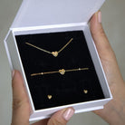 Gold heart-shaped jewellery set in a white gift box 
