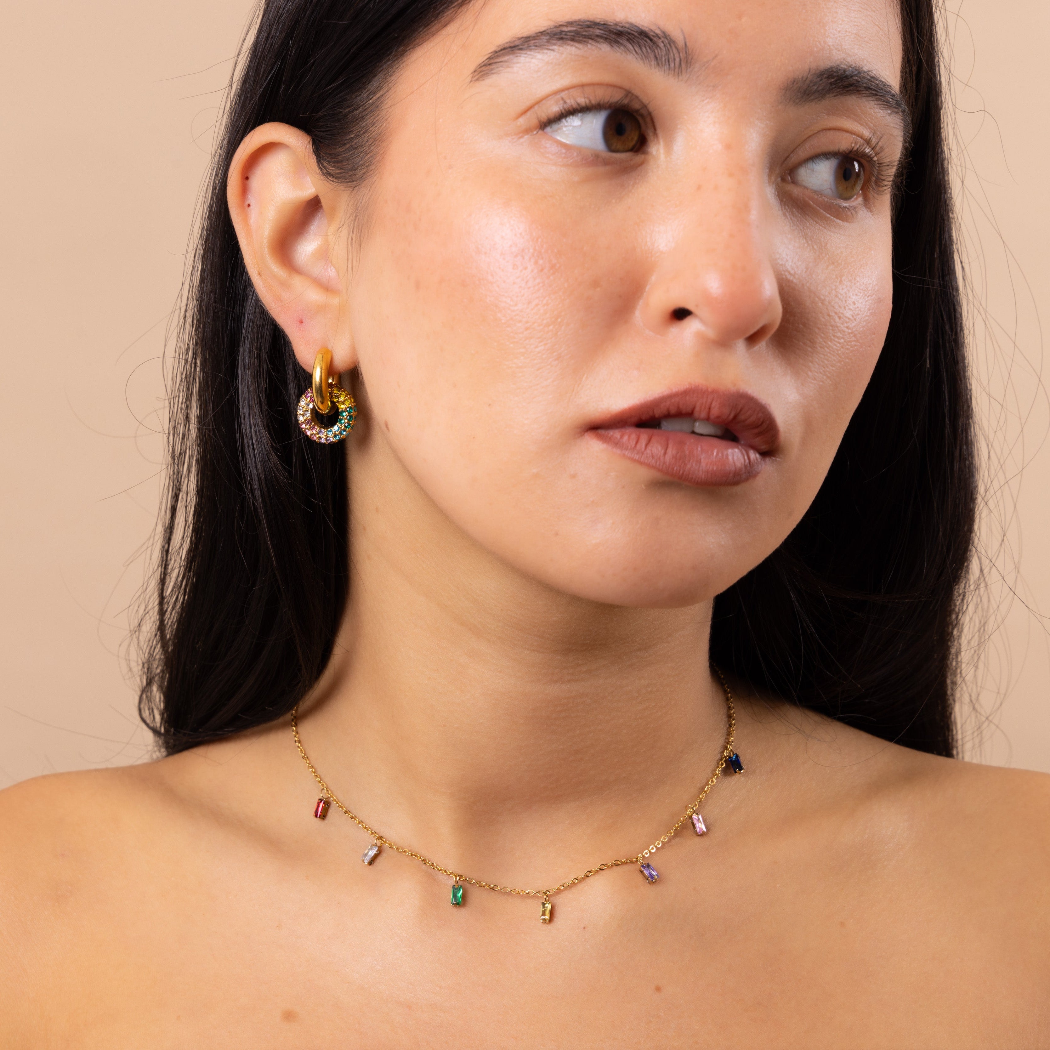 Model wearing Zoi Era Rainbow Charm Necklace with matching rainbow crystal hoop earrings – colourful waterproof anti-tarnish jewellery set.