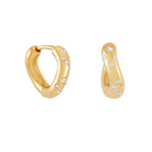 Gold wave hoop earrings with embedded crystal stones on a white background