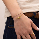 gold dainty tennis bracelet styled with dainty heart bracelet