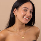 Minimalist gold necklace with celestial sun and star charms, everyday waterproof jewellery