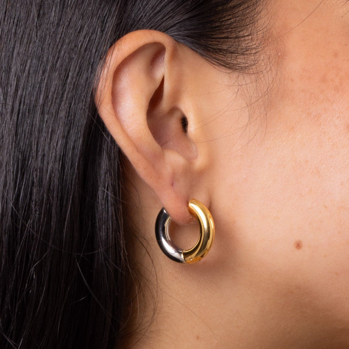 Model wearing Mixed Metal Chunky Hoop Earring – chunky two-tone gold and silver design, waterproof anti-tarnish everyday essential.