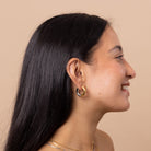 Model wearing Mixed Metal Chunky Hoop Earring – chunky two-tone gold and silver design, waterproof anti-tarnish everyday essential.