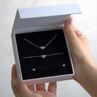 Silver heart-shaped jewelry set in a white gift box 