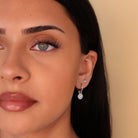 silver huggie hoop earrings with sun charm