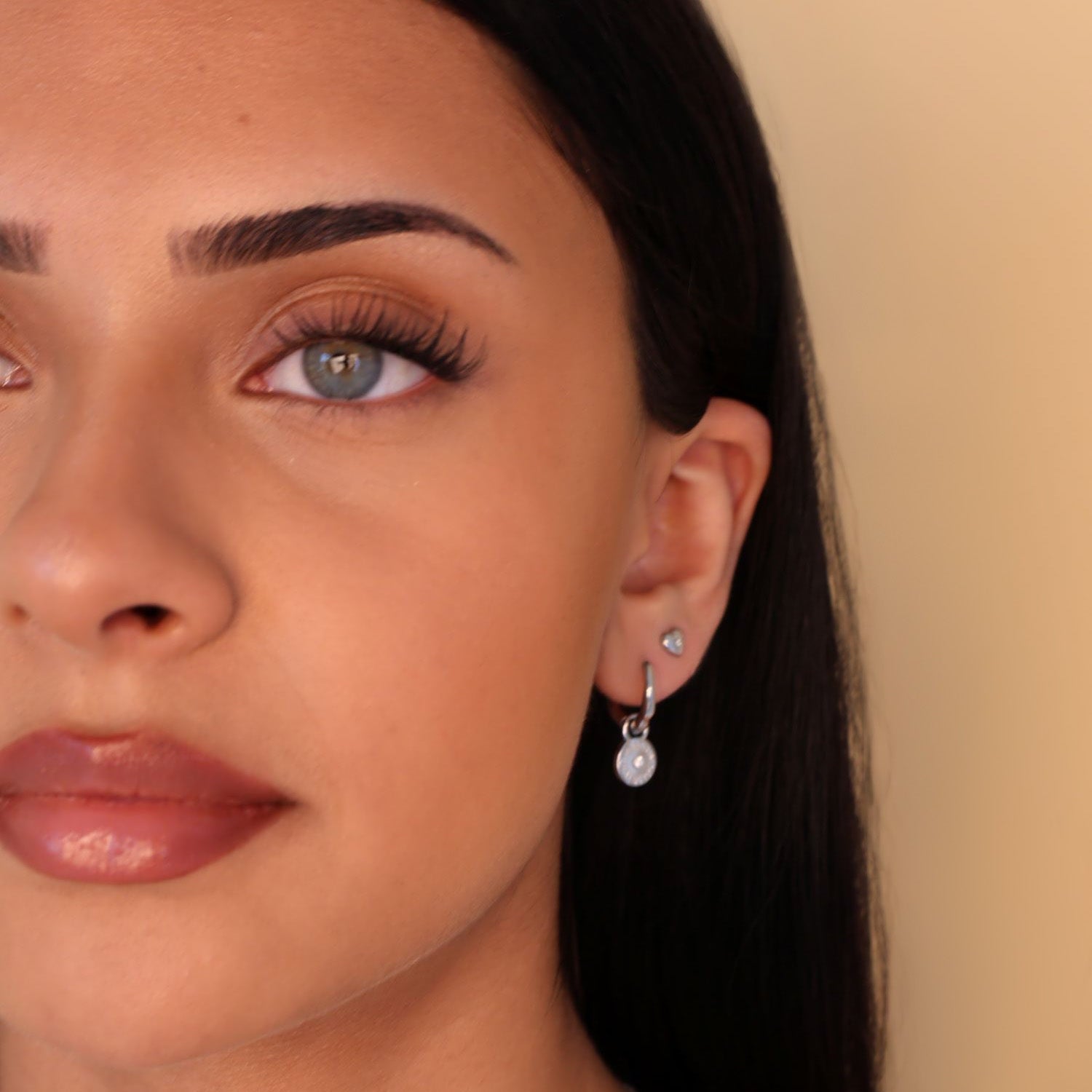 silver huggie hoop earrings with sun charm