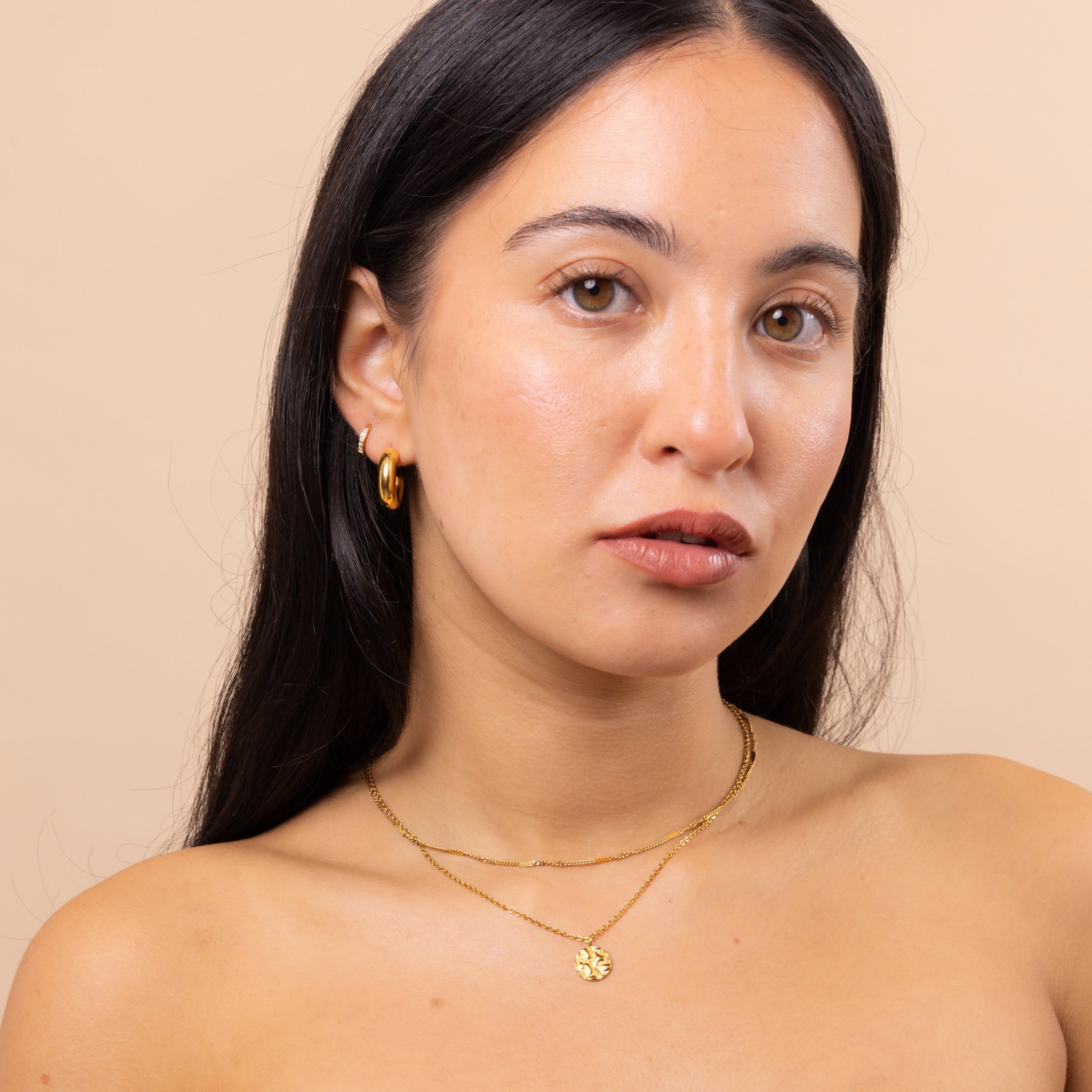 Model wearing Small Round Textured Pendant Necklace with another delicate chain – essential minimal layering necklace, waterproof and untarnished finish.